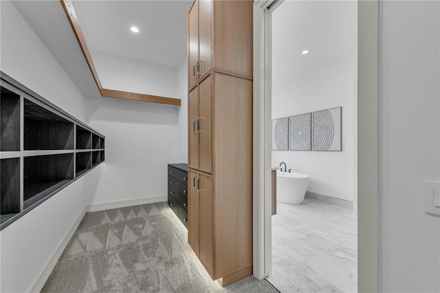 walk in closet with marble finish floor