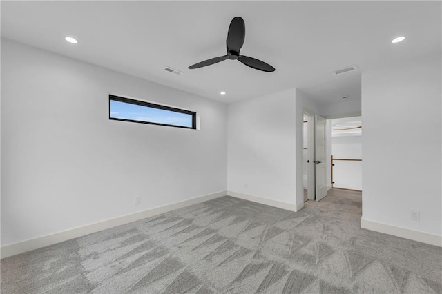 carpeted empty room featuring recessed lighting, visible vents, ceiling fan, and baseboards