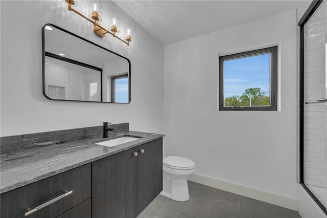 bathroom featuring a shower with door, baseboards, toilet, vanity, and tile patterned flooring