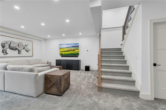 carpeted living area with stairway, recessed lighting, and baseboards