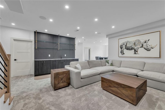 living area featuring recessed lighting, stairs, visible vents, and light carpet
