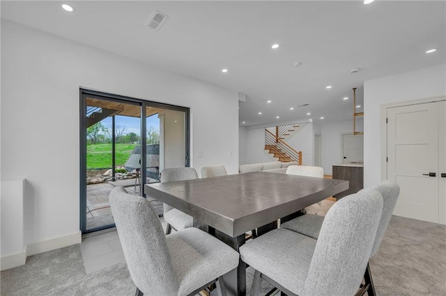 dining room featuring recessed lighting, stairs, visible vents, and light carpet
