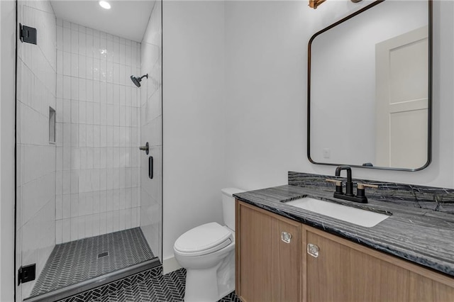 bathroom with recessed lighting, a shower stall, toilet, and vanity