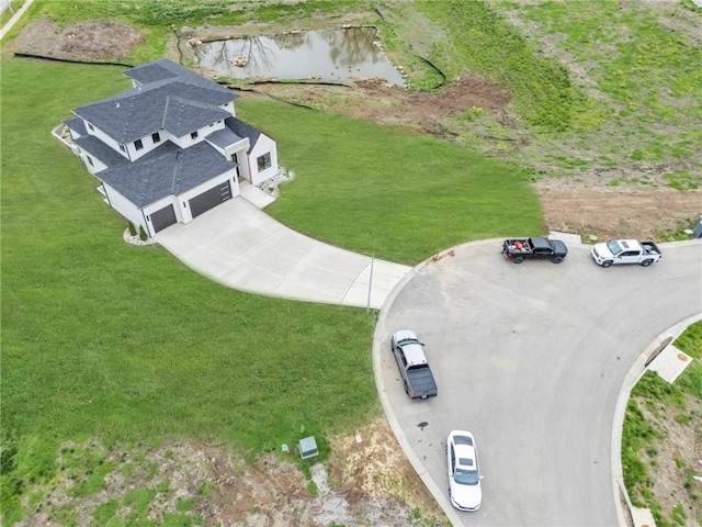 birds eye view of property with a water view