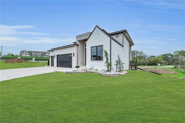 modern farmhouse with a garage, a front yard, and concrete driveway