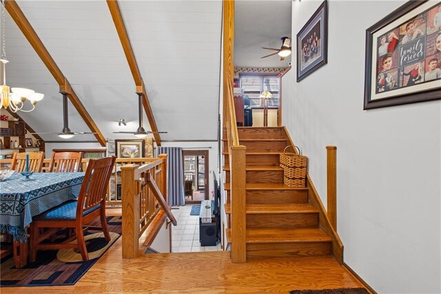 4012 NE Brooktree Ln, Kansas City, MO 64119 - staircase with ceiling fan with notable chandelier