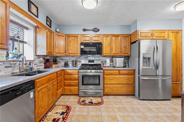 4012 NE Brooktree Ln, Kansas City, MO 64119 - kitchen with a sink, tasteful backsplash, appliances with stainless steel finishes, and a textured ceiling