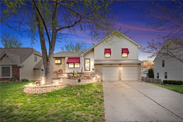4012 NE Brooktree Ln, Kansas City, MO 64119 - view of front of home featuring a garage, fence, driveway, and a lawn