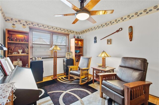 4012 NE Brooktree Ln, Kansas City, MO 64119 - living area with ceiling fan, baseboards, and a textured ceiling