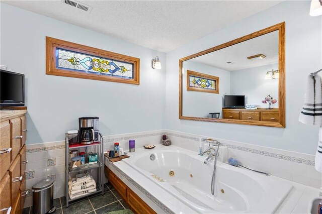 4012 NE Brooktree Ln, Kansas City, MO 64119 - full bathroom featuring visible vents, tile walls, a wainscoted wall, a jetted tub, and tile patterned floors