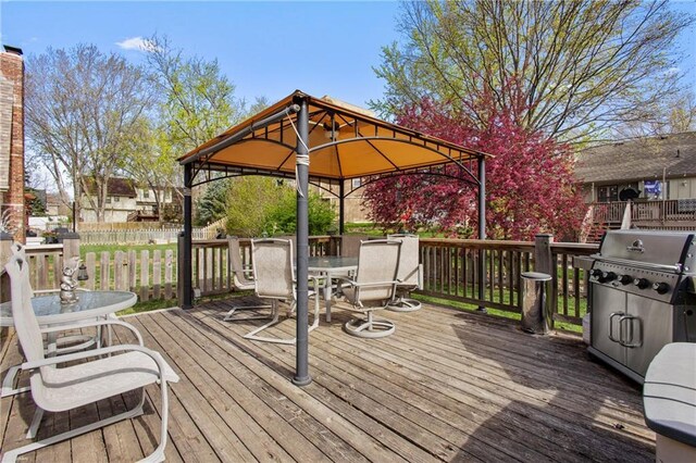 4012 NE Brooktree Ln, Kansas City, MO 64119 - wooden deck featuring grilling area, a gazebo, fence, and outdoor dining area