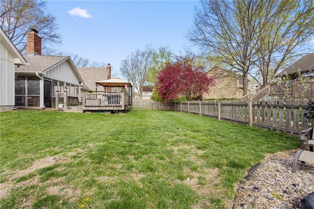 4012 NE Brooktree Ln, Kansas City, MO 64119 - view of yard with a sunroom, a fenced backyard, and a deck