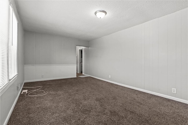 2701 Wilson Ave, Leavenworth, KS 66048 - carpeted spare room featuring a textured ceiling and baseboards