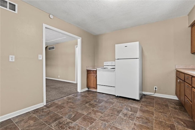 2701 Wilson Ave, Leavenworth, KS 66048 - kitchen with white appliances, brown cabinets, dark stone finish flooring, baseboards, and light countertops