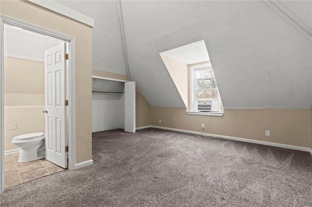 2701 Wilson Ave, Leavenworth, KS 66048 - additional living space featuring carpet flooring, vaulted ceiling, baseboards, and cooling unit