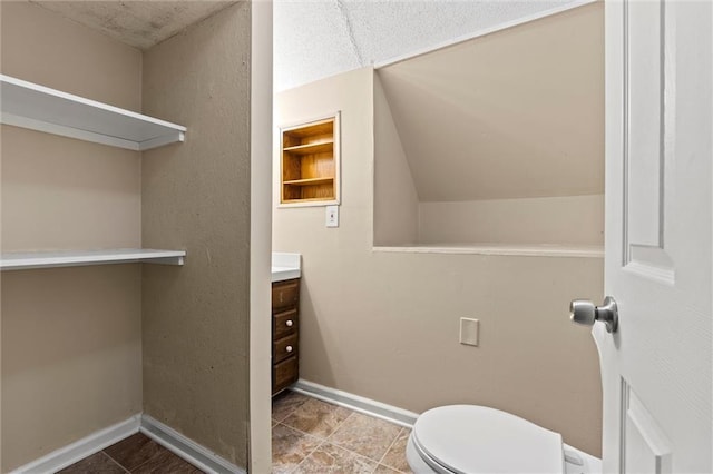 2701 Wilson Ave, Leavenworth, KS 66048 - half bath featuring vanity, toilet, and baseboards