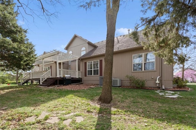 9708 Walnut Woods Dr, Kansas City, MO 64139 - exterior space with roof with shingles, a pergola, central air condition unit, a wooden deck, and a lawn