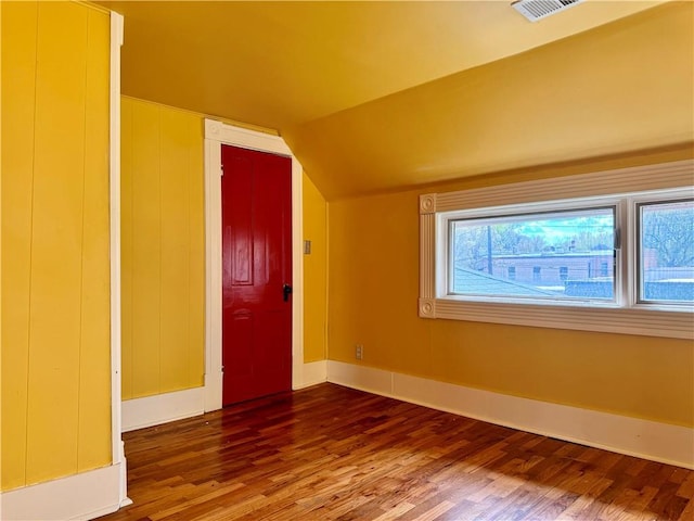 3640 Forest Ave, Kansas City, MO 64109 - additional living space featuring wood finished floors, baseboards, and vaulted ceiling