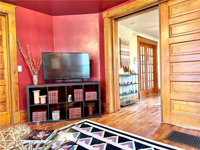 3640 Forest Ave, Kansas City, MO 64109 - living area featuring wood finished floors and french doors