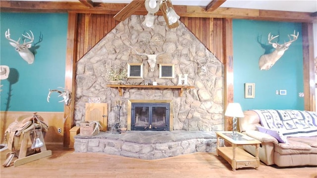 2101A Dove Rd, Longton, KS 67352 - living room with vaulted ceiling with beams, wood walls, wood finished floors, and a stone fireplace