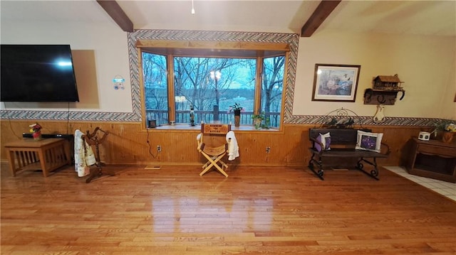 2101A Dove Rd, Longton, KS 67352 - living area featuring a wainscoted wall, light wood-style flooring, beamed ceiling, and wood walls