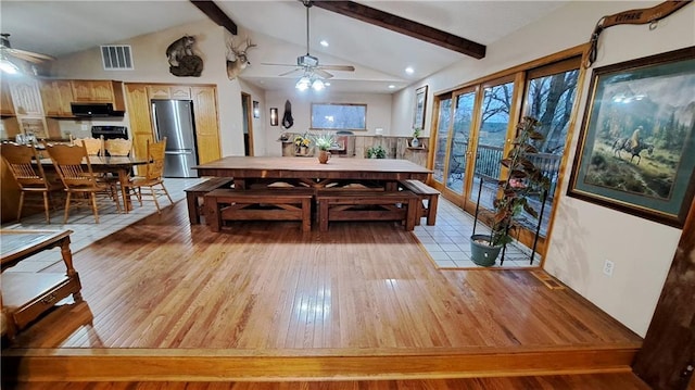 2101A Dove Rd, Longton, KS 67352 - dining room featuring vaulted ceiling with beams, visible vents, light wood-type flooring, and a ceiling fan
