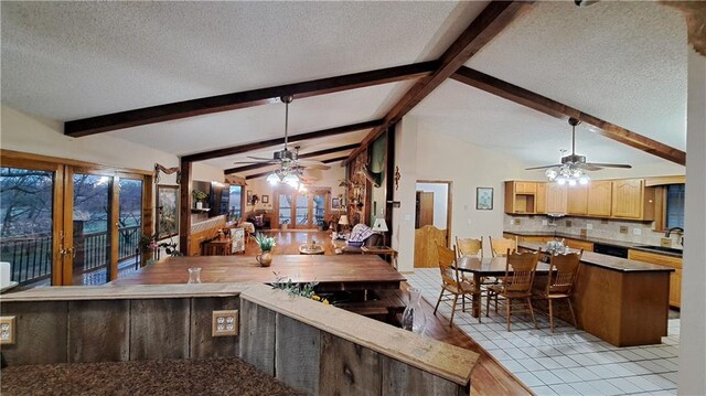 2101A Dove Rd, Longton, KS 67352 - kitchen featuring vaulted ceiling with beams, ceiling fan, backsplash, and a textured ceiling