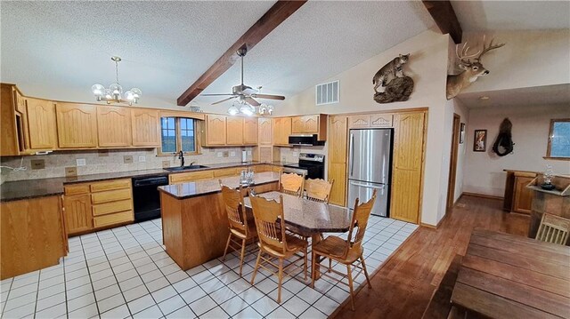 2101A Dove Rd, Longton, KS 67352 - kitchen with beam ceiling, a sink, appliances with stainless steel finishes, dark countertops, and visible vents