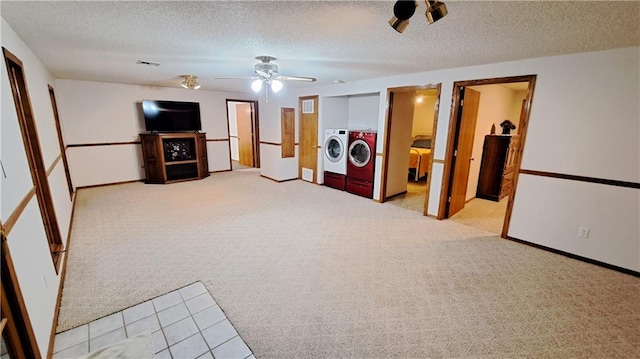 2101A Dove Rd, Longton, KS 67352 - carpeted living room featuring baseboards, a textured ceiling, visible vents, washing machine and dryer, and ceiling fan
