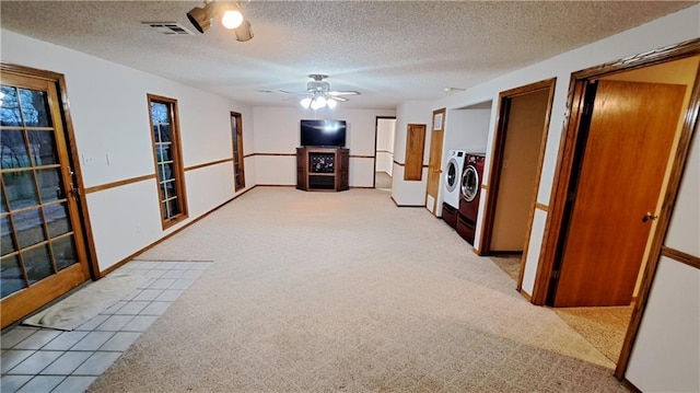 2101A Dove Rd, Longton, KS 67352 - carpeted living area with a ceiling fan, a textured ceiling, baseboards, visible vents, and washer and dryer