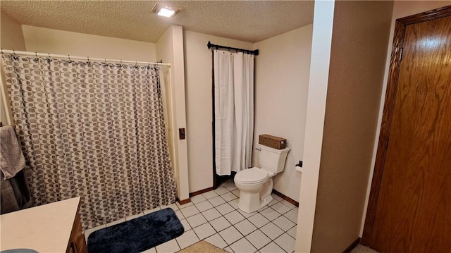 2101A Dove Rd, Longton, KS 67352 - bathroom featuring tile patterned floors, toilet, baseboards, and a textured ceiling