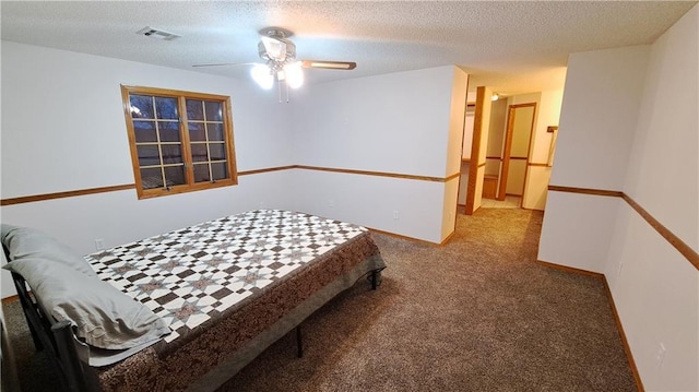 2101A Dove Rd, Longton, KS 67352 - carpeted bedroom featuring baseboards, a textured ceiling, visible vents, and a ceiling fan