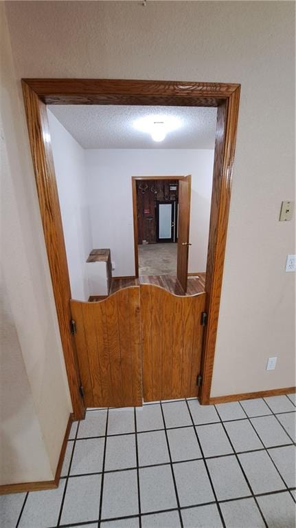 2101A Dove Rd, Longton, KS 67352 - hall featuring light tile patterned flooring and a textured ceiling
