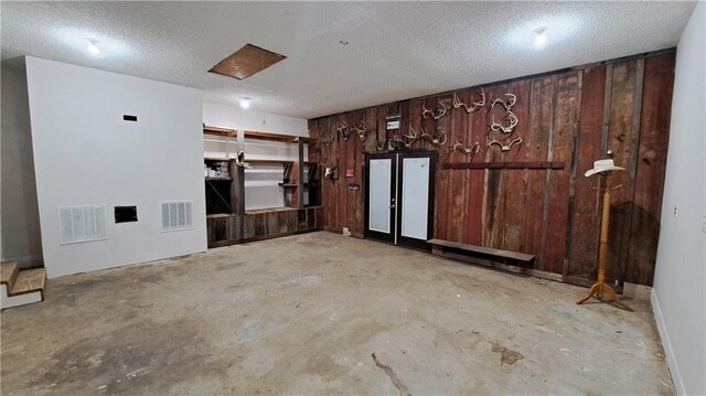 2101A Dove Rd, Longton, KS 67352 - empty room with concrete floors, wooden walls, and visible vents