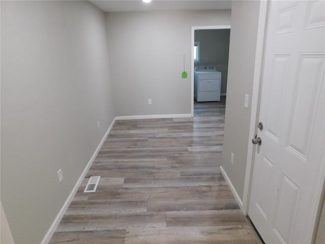 308 W 5th St, Pittsburg, KS 66762 - corridor with wood finished floors, washer / dryer, baseboards, and visible vents
