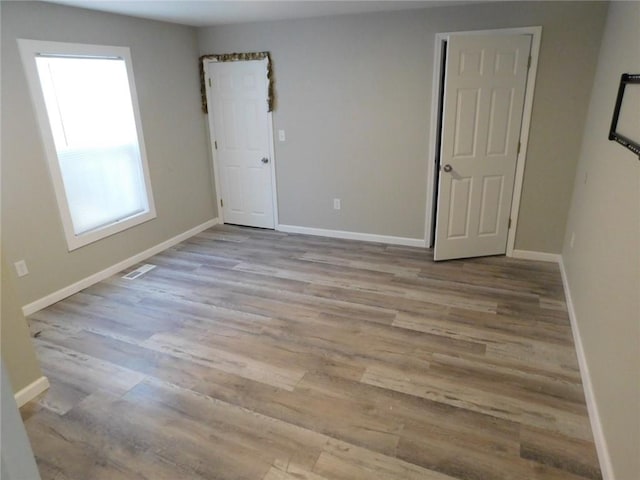 308 W 5th St, Pittsburg, KS 66762 - unfurnished room featuring wood finished floors, baseboards, and visible vents