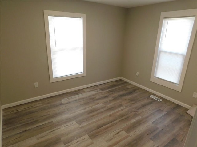 308 W 5th St, Pittsburg, KS 66762 - spare room featuring wood finished floors, baseboards, and visible vents