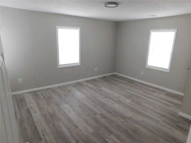 308 W 5th St, Pittsburg, KS 66762 - unfurnished room with baseboards, a textured ceiling, and wood finished floors
