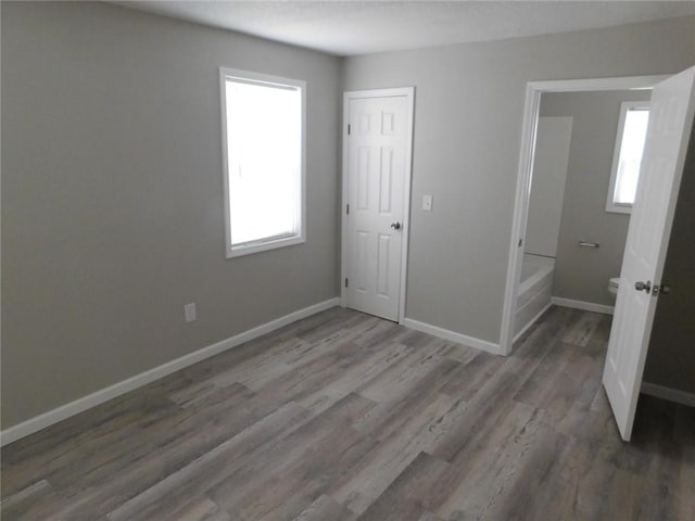 308 W 5th St, Pittsburg, KS 66762 - unfurnished bedroom with baseboards and wood finished floors