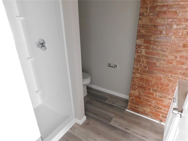 308 W 5th St, Pittsburg, KS 66762 - full bath with toilet, baseboards, brick wall, walk in shower, and wood finished floors