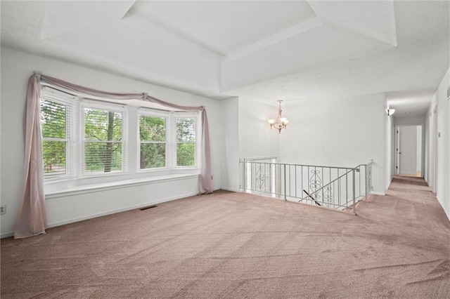 14404 Kansas Ave, Bonner Springs, KS 66012 - unfurnished room with carpet flooring, a chandelier, a raised ceiling, and baseboards