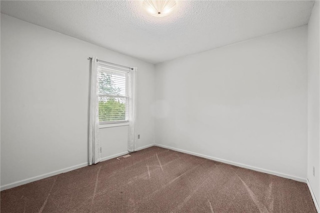 14404 Kansas Ave, Bonner Springs, KS 66012 - carpeted empty room with a textured ceiling and baseboards