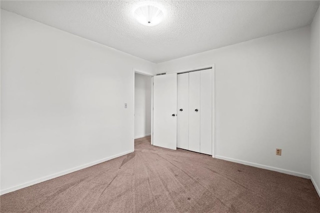 14404 Kansas Ave, Bonner Springs, KS 66012 - unfurnished bedroom featuring carpet flooring, a closet, a textured ceiling, and baseboards
