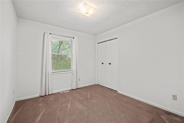 14404 Kansas Ave, Bonner Springs, KS 66012 - carpeted spare room featuring a textured ceiling and baseboards