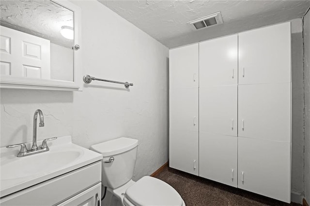14404 Kansas Ave, Bonner Springs, KS 66012 - bathroom featuring vanity, toilet, and a textured ceiling