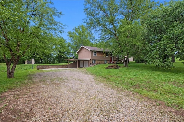 14404 Kansas Ave, Bonner Springs, KS 66012 - view of front facade featuring driveway, a garage, and a front yard