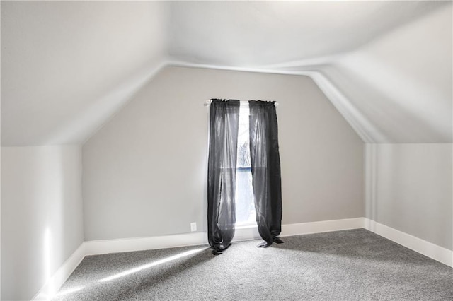 additional living space with plenty of natural light, baseboards, and lofted ceiling