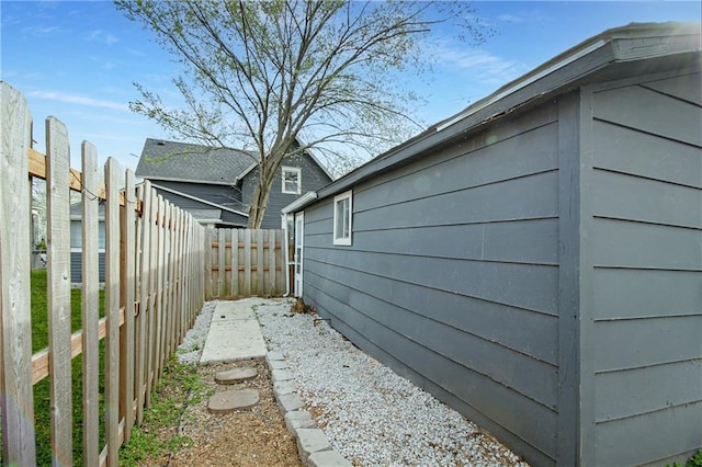 view of side of home featuring fence