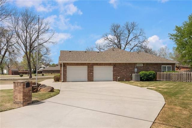 ranch-style home featuring a garage, concrete driveway, fence, a front yard, and brick siding