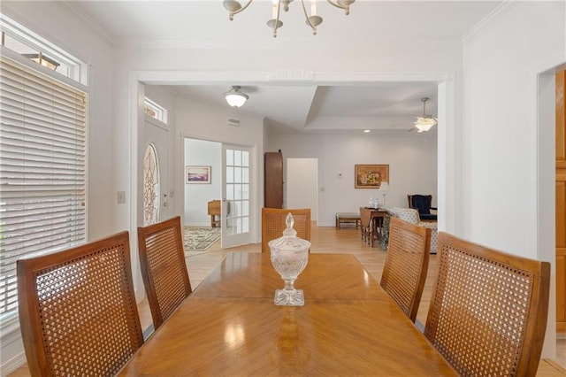 dining area featuring a notable chandelier, a wealth of natural light, and crown molding